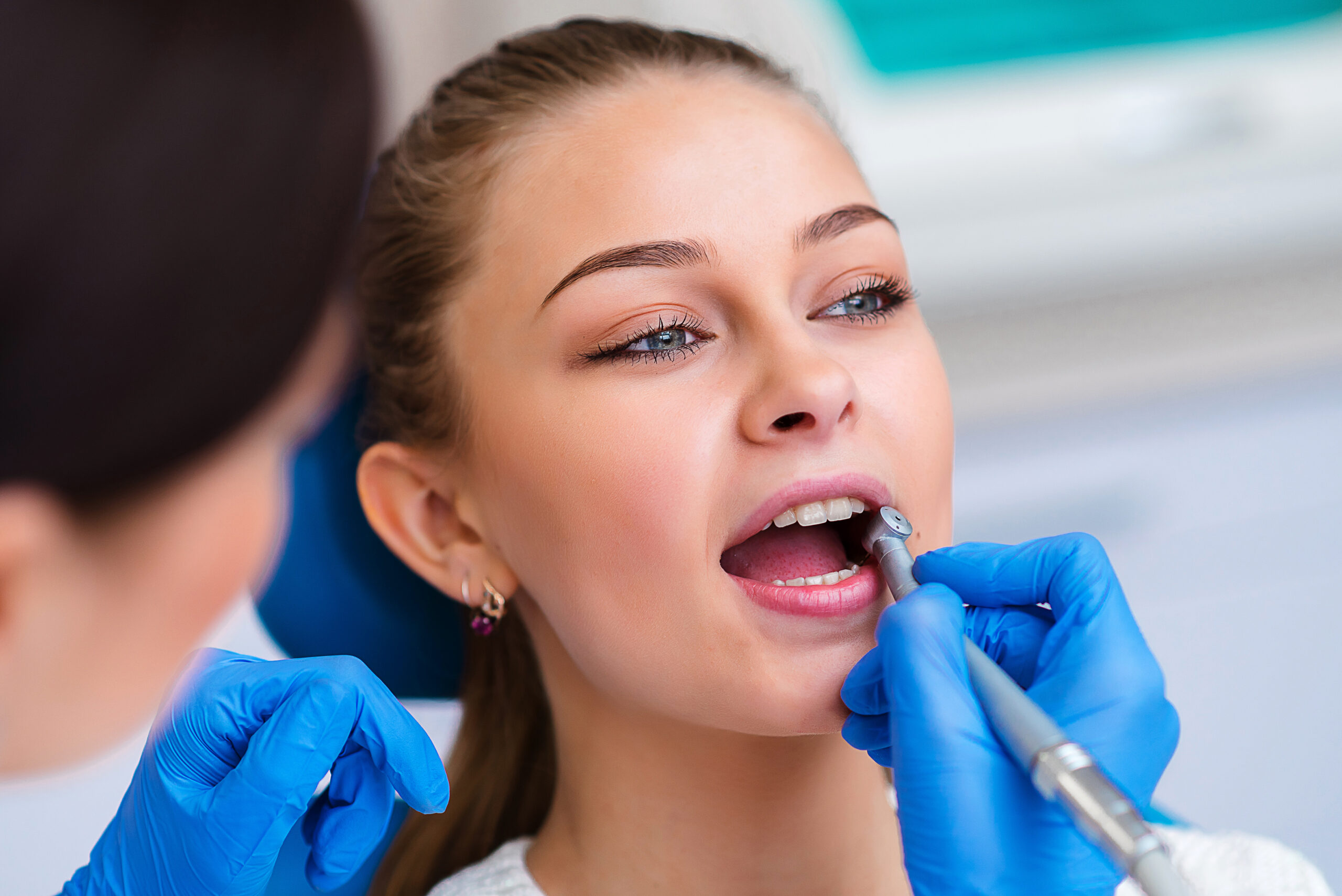 Doctor examining patient's teeth, closeup. Cosmetic dentistry